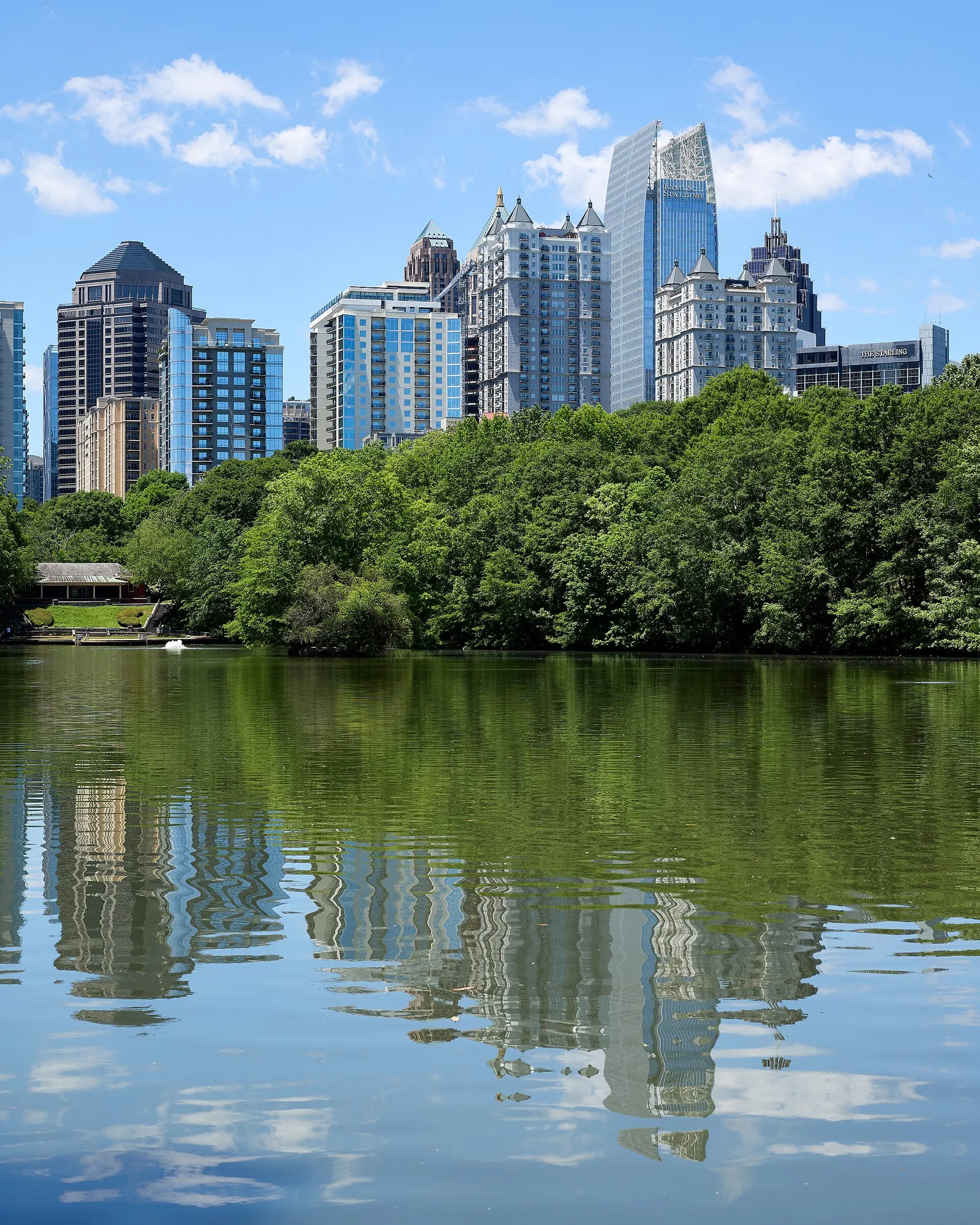 Lake Clara Meer in Piedmont Park with the Midtown Atlanta skyline rising behind the trees
